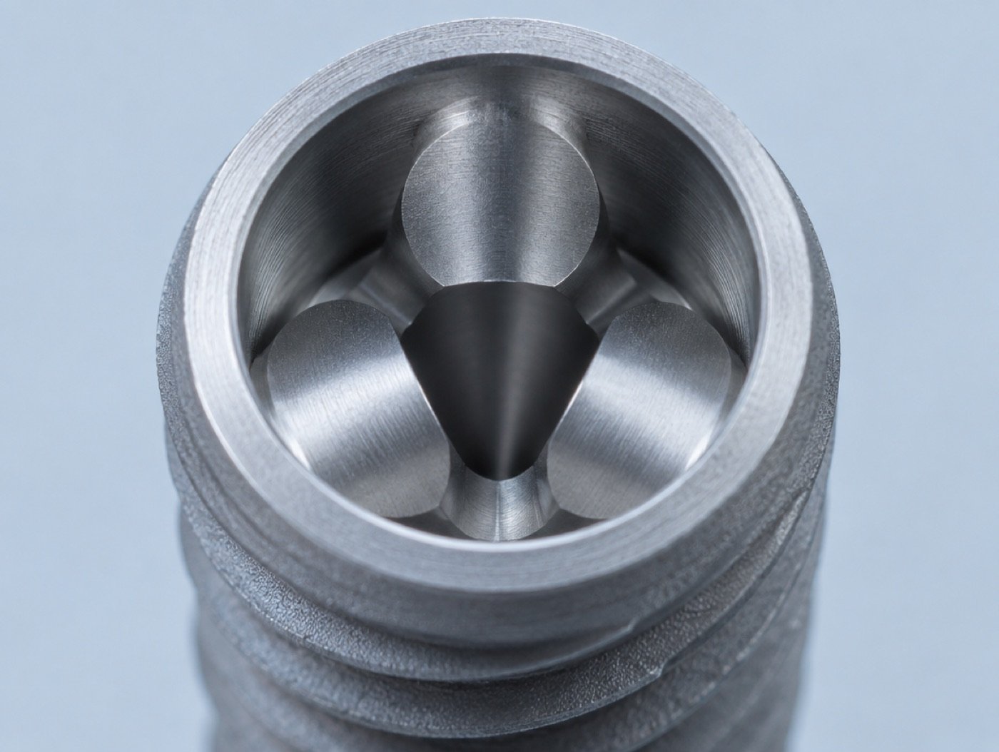 Macro photo of a generic implant with a three-lobed connection (not a Nobel Biocare product image)